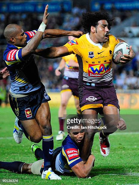 Sam Thaiday of the Broncos is tackled by Michael Bani and Willie Tonga of the Cowboys during the round 25 NRL match between the North Queensland...