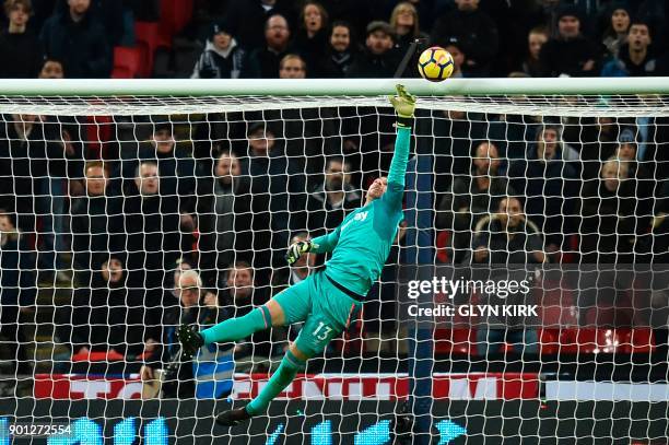 West Ham United's Spanish goalkeeper Adrian makes a save during the English Premier League football match between Tottenham Hotspur and West Ham...