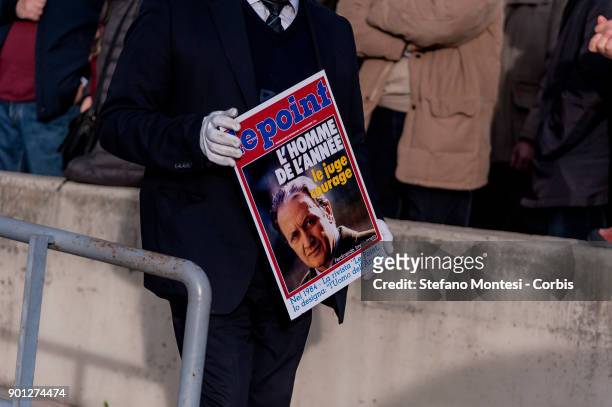Funeral pump attendant puts in the funeral chariot a copy of a 1984 front page of Le Point that defines Imposimato, man of the year and bravery judge...