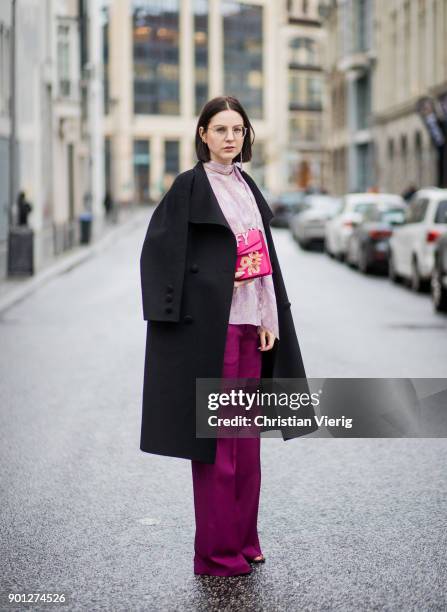 Maria Barteczko wearing black long vintage wool coat Saint Laurent, glasses, purple ruffled blouse with trumpet sleeves Chloe, pink wide leg palazzo...