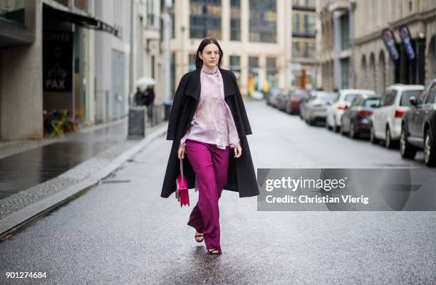 Maria Barteczko wearing black long vintage wool coat Saint Laurent, glasses, purple ruffled blouse with trumpet sleeves Chloe, pink wide leg palazzo...