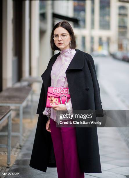 Maria Barteczko wearing black long vintage wool coat Saint Laurent, glasses, purple ruffled blouse with trumpet sleeves Chloe, pink wide leg palazzo...