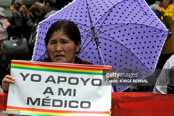 Woman holds a poster reading "I support my doctor" during a protest against a new law that penalizes medical malpractice, near the Health Ministry in...