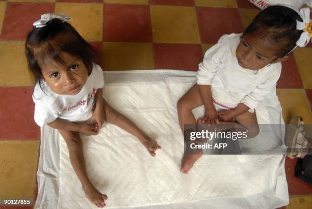 Three-year-old Vidalia Agustin and her six-year-old sister Maribel, affected by chronic malnutrition, August 27 at a shelter of the Castillo Cordova...