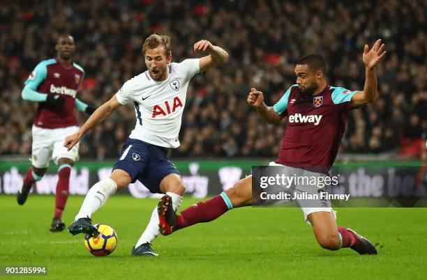 Harry Kane of Tottenham Hotspur is challenged by Winston Reid of West Ham United during the Premier League match between Tottenham Hotspur and West...