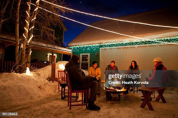 group of friends enjoying winter bonfire. - hot latin nights stock pictures, royalty-free photos & images