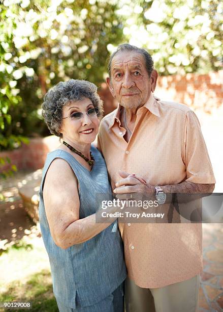 senior couple embracing outdoors - troy bond stock pictures, royalty-free photos & images