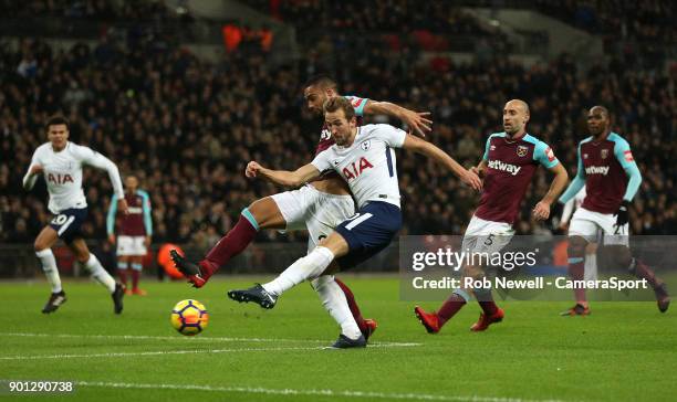 Tottenham Hotspur's Harry Kane gets in a shot ahead of West Ham United's Winston Reid during the Premier League match between Tottenham Hotspur and...