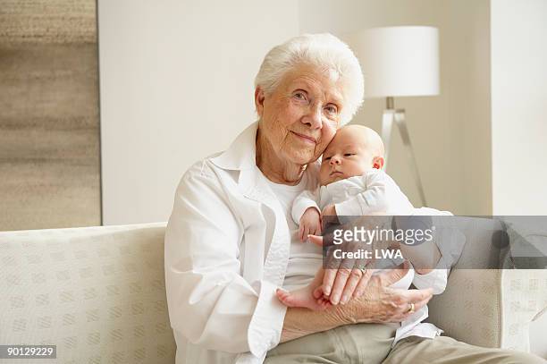 great grandmother holding great grandson - great grandmother imagens e fotografias de stock