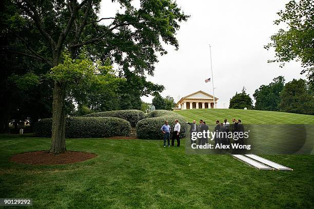 Funeral planners discuss at the grave site of Sen. Edward Kennedy at Arlington National Cemetery August 28, 2009 in Arlington, Virginia. Sen. Kennedy...