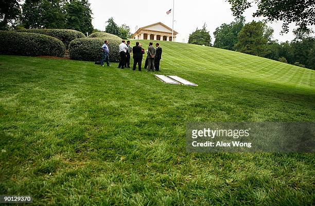 Funeral planners discuss at the grave site of Sen. Edward Kennedy at Arlington National Cemetery August 28, 2009 in Arlington, Virginia. Sen. Kennedy...