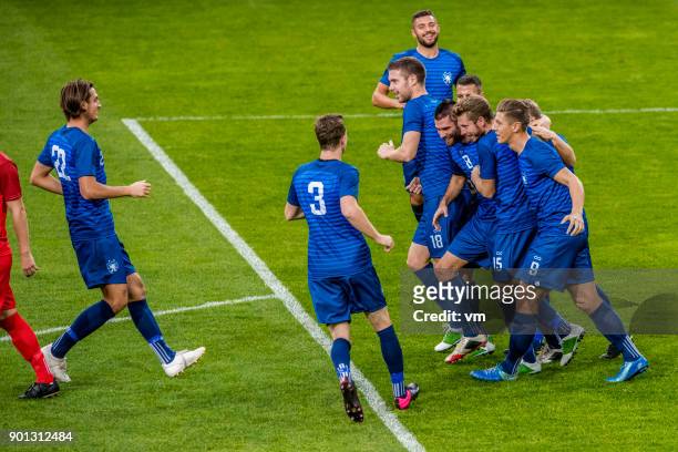 soccer team in blue celebrating a goal - soccer player stock pictures, royalty-free photos & images