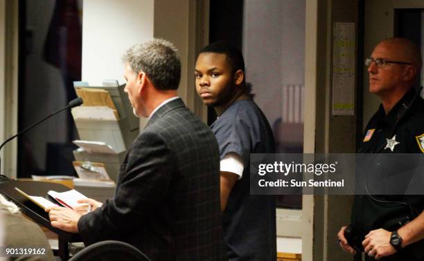 Malachi Love-Robinson of West Palm Beach, Fla., looks over at his grandfather during his first appearance court hearing on March 2 at the Palm Beach...