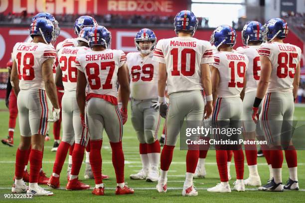 Roger Lewis, Orleans Darkwa, Sterling Shepard, Eli Manning, Travis Rudolph and Rhett Ellison of the New York Giants huddle up during the first half...