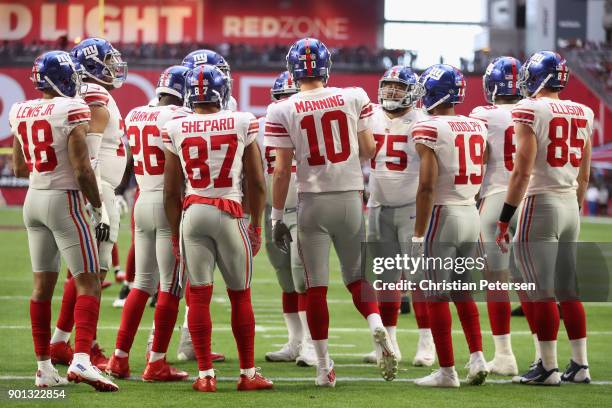 Roger Lewis, Orleans Darkwa, Sterling Shepard, Eli Manning, Travis Rudolph and Rhett Ellison of the New York Giants huddle up during the first half...