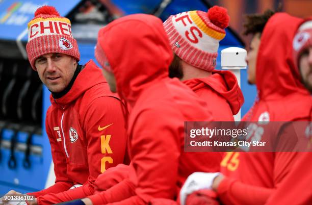 Kansas City Chiefs quarterback Alex Smith, left, sits on a heated bench prior to a game against the Denver Broncos on December 31 at Sports Authority...