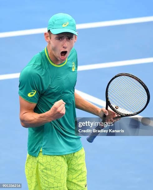 Alex De Minaur of Australia celebrates after winning the first set in his match against Michael Mmoh of USA during day six of the 2018 Brisbane...