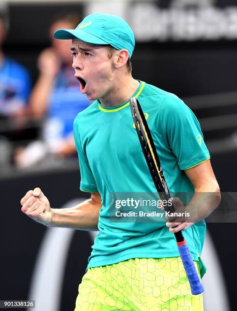 Alex De Minaur of Australia celebrates after winning a break point in his match against Michael Mmoh of USA during day six of the 2018 Brisbane...