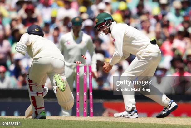 Cameron Bancroft of Australia knocks off he bails to run out Mason Crane of England during day two of the Fifth Test match in the 2017/18 Ashes...