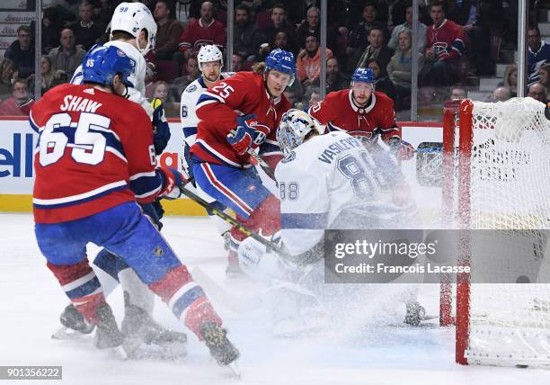 Andrei Vasilevskiy of the Tampa Bay Lightning makes a save off the shot by Andrew Shaw and Jacob De La Rose of the Montreal Canadiens in the NHL game...