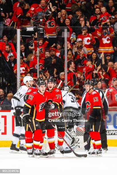 Johnny Gaudreau, Sean Monahan and teammates of the Calgary Flames celebrate in an NHL game on January 4, 2018 at the Scotiabank Saddledome in...