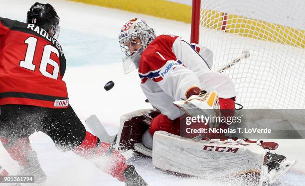 Jakub Skarek of Czech Republic eyes a rebound off the stick of Taylor Raddysh of Canada during the third period of play in the IIHF World Junior...