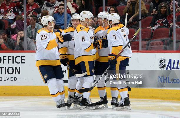 Craig Smith of the Nashville Predators is congratulated by teammates Alexei Emelin, Kevin Fiala, Kyle Turris and Yannick Weber after his third period...