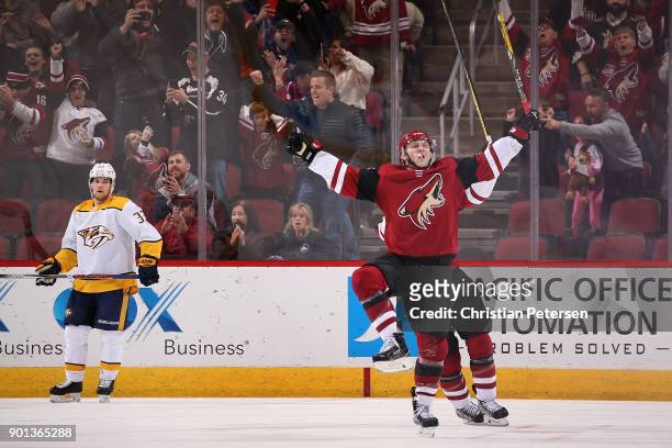 Christian Fischer of the Arizona Coyotes celebrates after scoring the game winning overtime goal against the Nashville Predators in the NHL game at...
