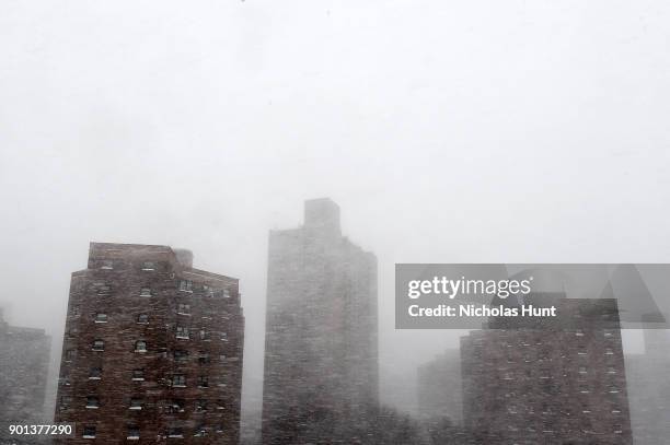 Buildings eclipsed by snow during a massive winter storm on January 4, 2018 in New York City. As a major winter storm moves up the Northeast...