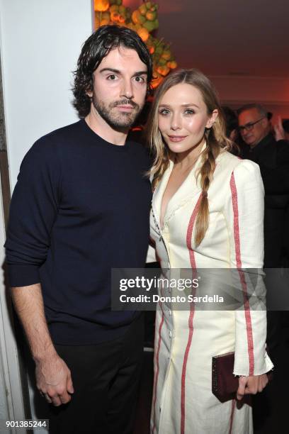 Robbie Arnett and Elizabeth Olsen attend W Magazine's Celebration of its 'Best Performances' Portfolio and the Golden Globes with Audi, Dior, and Dom...