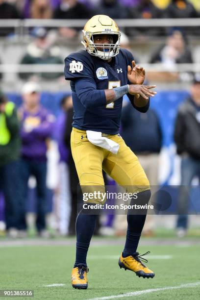 Notre Dame Fighting Irish quarterback Brandon Wimbush watches his pass during the first half of the Citrus Bowl game between the Notre Dame Fighting...