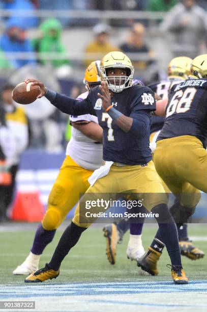 Notre Dame Fighting Irish quarterback Brandon Wimbush throws a pass backwards on a trick play during the first half of the Citrus Bowl game between...