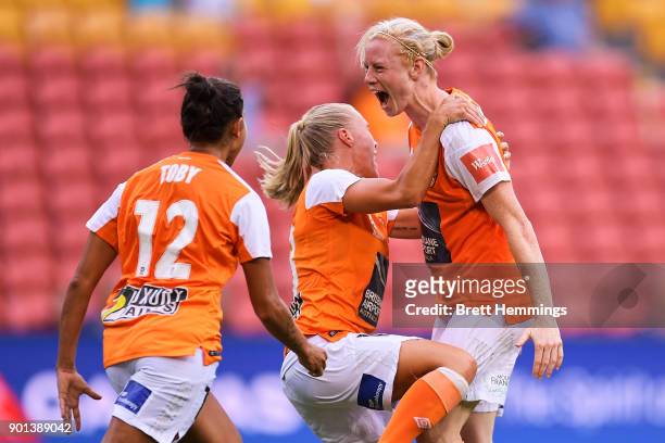 Clare Polkinghorne of Brisbane celebrates scoring a goal with team mates during the round ten W-League match between the Brisbane Roar and Melbourne...