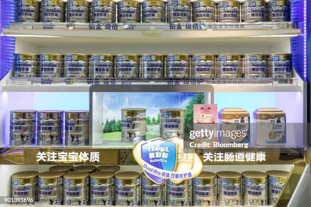 Cans of Similac infant formula, produced by Abbott Laboratories, are displayed for sale at a Shanghai Aiyingshi Co. Babemax store in Shanghai, China,...