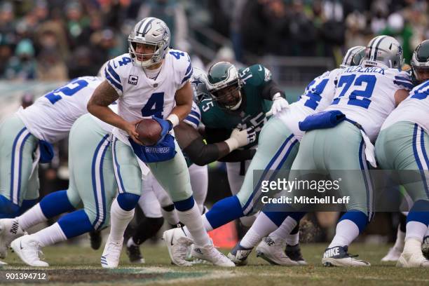 Dak Prescott of the Dallas Cowboys drops back against Vinny Curry of the Philadelphia Eagles at Lincoln Financial Field on December 31, 2017 in...