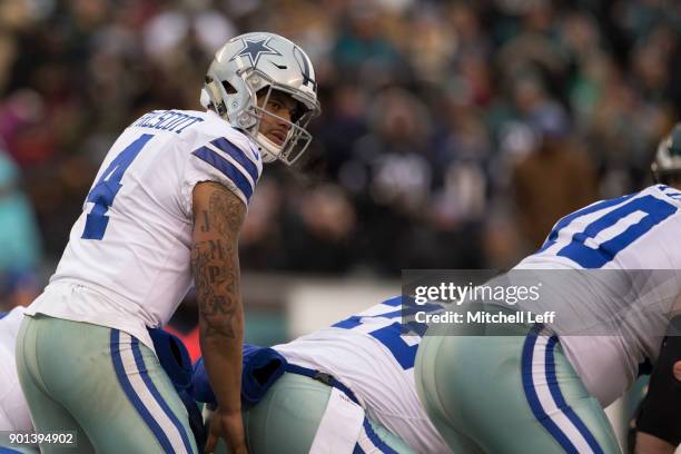 Dak Prescott of the Dallas Cowboys looks on under center against the Philadelphia Eagles at Lincoln Financial Field on December 31, 2017 in...