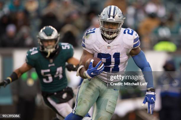 Ezekiel Elliott of the Dallas Cowboys runs the ball against Kamu Grugier-Hill of the Philadelphia Eagles at Lincoln Financial Field on December 31,...