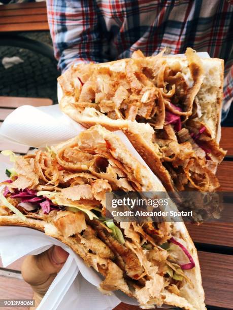 eating doner kebab from personal perspective - kebab stock-fotos und bilder