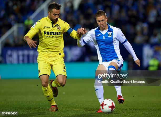 Raul Garcia of Leganes competes for the ball with Mario Gaspar of Villarreal during the Copa del Rey, Round of 16, first Leg match between UD Leganes...