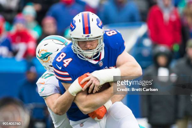 Kiko Alonso of the Miami Dolphins tackles Nick O'Leary of the Buffalo Bills during the first half at New Era Field on December 17, 2017 in Orchard...