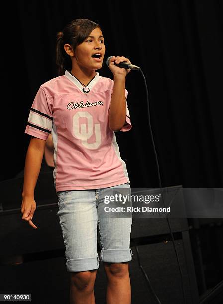 Checotah fifth-grader Kennedee Rittenhouse performs at Checotah High School during a surprise students with more than $117,000 in new music...