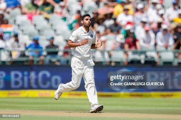 Indian bowler Bhuvneshwar Kumar celebrates the dismissal of South African batsman Hashim Amla during Day One of the First Test cricket match between...