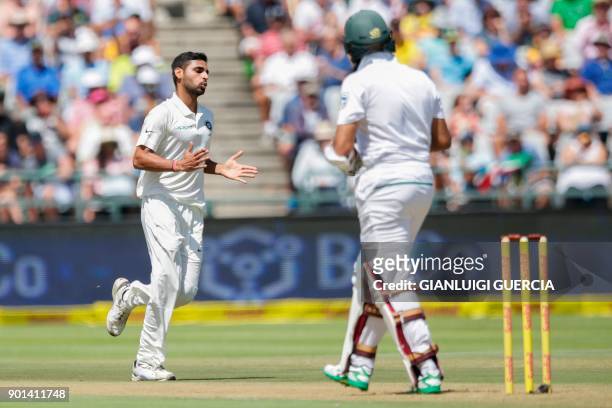 Indian bowler Bhuvneshwar Kumar celebrates the dismissal of South African batsman Hashim Amla during Day One of the First Test cricket match between...