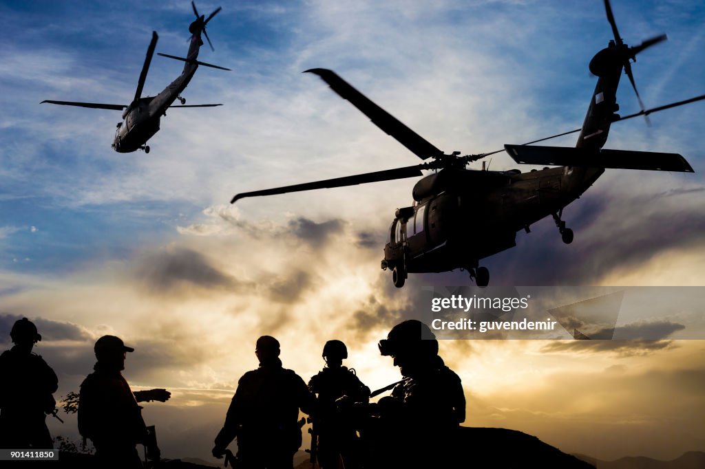 Silhouettes of soldiers during Military Mission at dusk