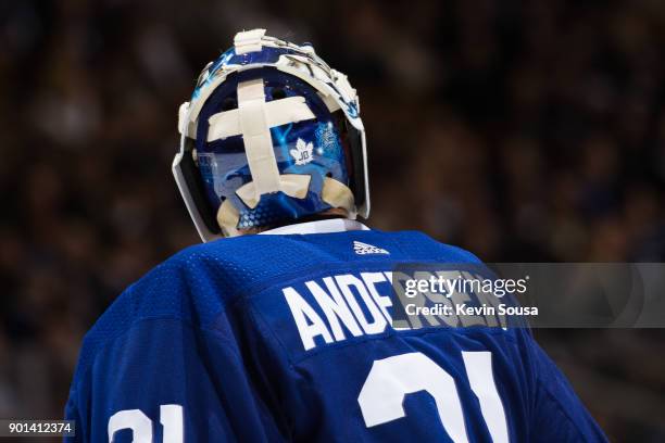 Frederik Andersen of the Toronto Maple Leafs wears a JB helmet to honour the passing of Leafs legend Johnny Bower during an NHL game against the...