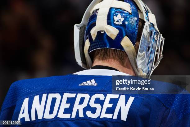 Frederik Andersen of the Toronto Maple Leafs wears a JB helmet to honour the passing of Leafs legend Johnny Bower during an NHL game against the...