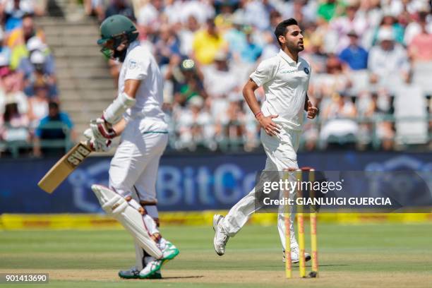 Indian bowler Bhuvneshwar Kumar celebrates the dismissal of South African batsman Hashim Amla during Day One of the First Test cricket match between...