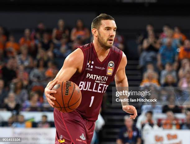 Adam Gibson of the Bullets dribbles the ball during the round 13 NBL match between the Cairns Taipans and the Brisbane Bullets at the Cairns...