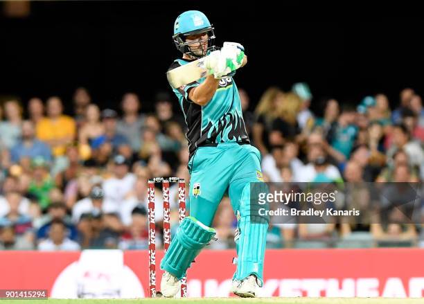 Joe Burns of the Heat hits the ball over the boundary for a six during the Big Bash League match between the Brisbane Heat and the Perth Scorchers at...