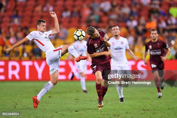 Thomas Kristensen of Brisbane and Oriol Riera of the Wanderers contest the ball during the round 14 A-League match between the Brisbane Roar and the...